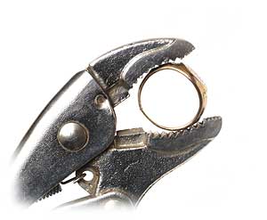 Hold gold ring with pliers